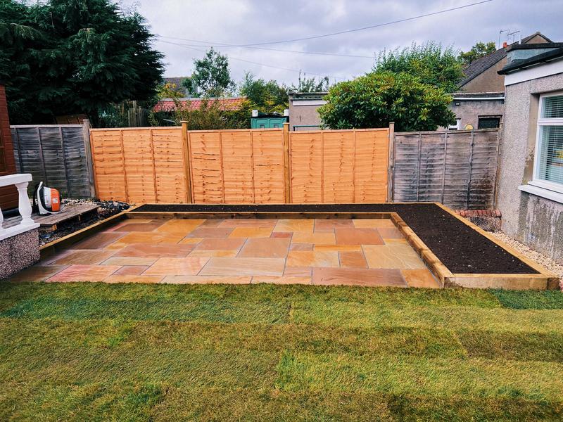 Sandstone patio with raised beds and new fencing