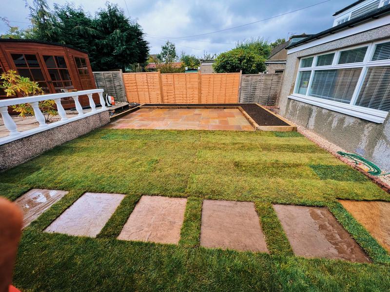 New turf and stepping stones with patio area